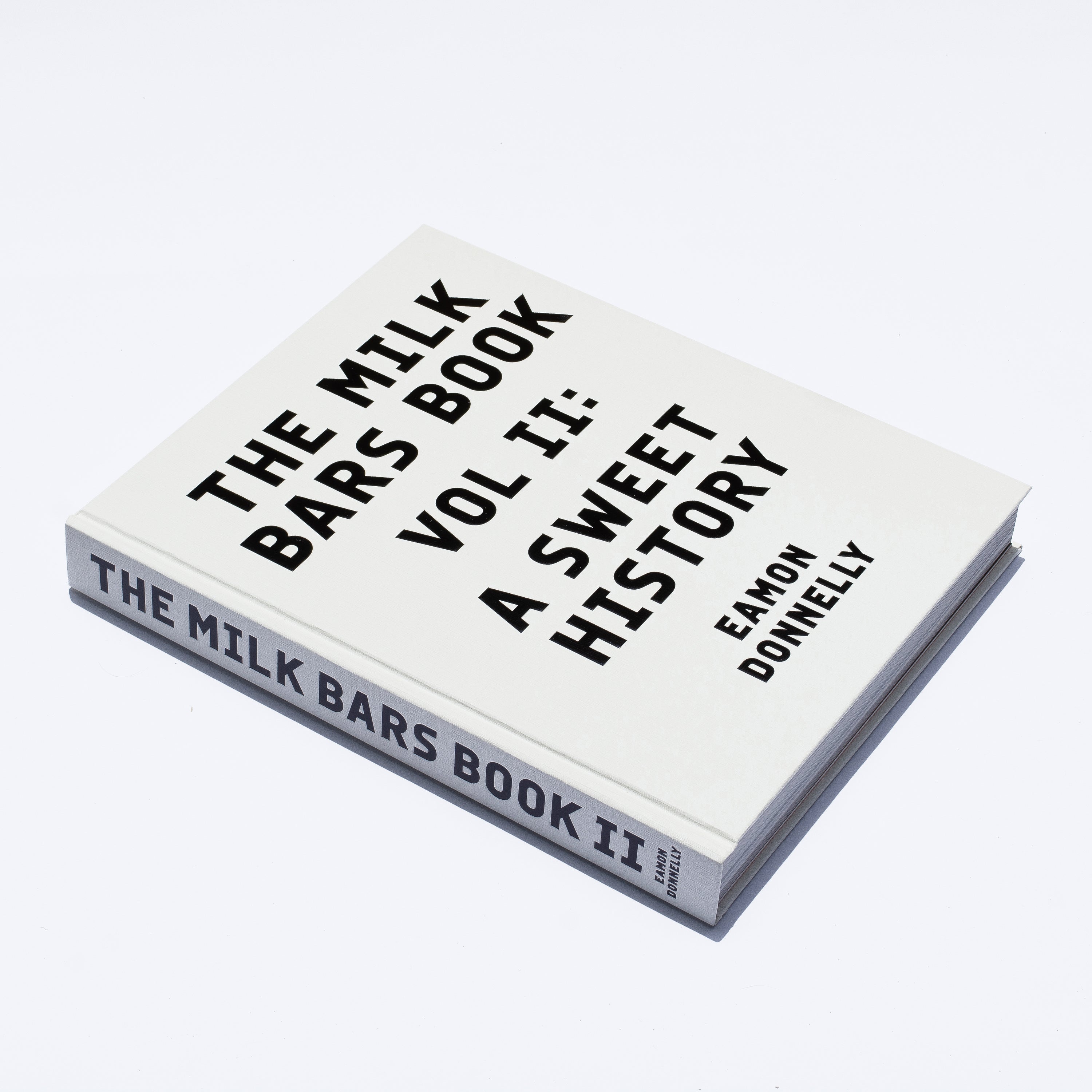DISCOUNTED SECONDS STOCK of The Milk Bars Book. Volume II: A Sweet History [2023] — minor factory / carton damage, smudge, defect or scuff on the cover, spine, internal pages or end papers, otherwise “as new”
